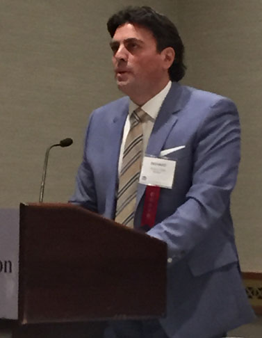 Richard A. Klass in blue suit with colorful tie at the annual meeting of the New York State Bar Association's General Practice Section, February 23, 2015