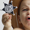Photo of toddler with sheriff's star illustrating article by Richard Klass Esq. about New York City marshals.