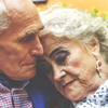 Gray-haired couple in embrace illustrating article by Richard Klass Esq. about Tenancy by the Entirety