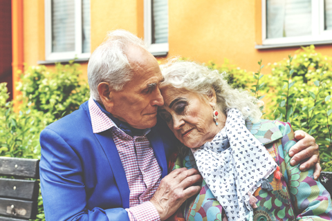 Gray-haired couple in embrace illustrating article by Richard Klass Esq. about Tenancy by the Entirety