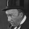 Man in top hat with nervous expression